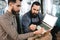 Two bearded men check quality of barley malt while in brewery. Process of beer manufacturing.