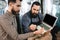 Two bearded men check quality of barley malt while in brewery. Process of beer manufacturing.