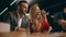 Two bearded men and young woman are talking make bets gambiling in a casino. Entertainment industry and luxury lifestyle