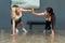 Two beautiful Asian girls in gym clothes are doing bodyweight training exercises with smiles on their faces in fitness center