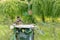 Two beautiful bird sitting on a metal cage on blurred green background with copy space. natural concept