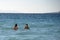 Two beautiful black hair mexican girls swimming in Cortez Sea on baja california beach