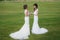 Two beautiful brides holding hands on the green field