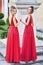 Two beautiful bridesmaids girls blonde and brunette ladies wearing elegant full length red chiffon bridesmaid dress with