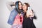 Two beautiful brunette women (girls) teenagers spend time together having fun, make funny faces, making selfie. Retro outfit: blu