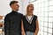 Two beautiful business workers wearing business style standing at the office looking away to side with smile on face, natural