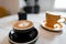 Two beautiful ceramic coffee cups stand on a table in a cafe with hot cappuccino and fragrant latte. Great morning coffee break.