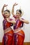 Two Beautiful Classical Odissi dancers performing Odissi Dance on stage at Konark Temple, Odisha, India.