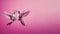 Two beautiful colorful hummingbirds in love fly together and kiss each other on a pink background