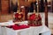 Two beautiful crowns with gold and red cloth stand on a table in the church before the baptism of the baby