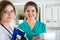 Two beautiful female medicine doctors working at their office