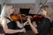 Two beautiful female violinists playing violin