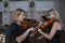 Two beautiful female violinists playing violin