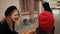 Two beautiful French women in black jackets and red beret fight with loaves,