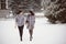 Two beautiful girlfriends hugging and smiling outdoors in winter. Two young female friends portrait closeup. Retouched, natural