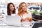 Two beautiful girls in cafe with laptop