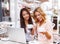 Two beautiful girls in cafe with laptop