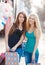 Two beautiful girls with colorful shopping bags