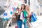 Two beautiful girls with colorful shopping bags