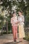 Two beautiful girls getting dressed in Thai Traditional Costume