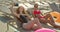 Two beautiful girls having fun taking selfie photo with smart phone camera at swimming pool. Beautiful ladies in
