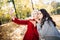 Two beautiful girls making selfie and blow kiss in autumn park