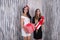 Two beautiful girls with present boxes posing in studio