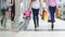 Two beautiful girls with shopping bags come out of