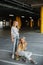 Two beautiful girls skateboarding, having fun and playing in the parking lot