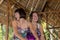 Two Beautiful happy young girls sitting in a wooden gazebo at sunny day. and having fun, smiling and laughing. Tropical