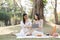 Two beautiful LGBT young women in casual clothes and summer hats Carefree woman having a picnic outside Positive model