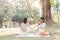 Two beautiful LGBT young women in casual clothes and summer hats Carefree woman having a picnic outside Positive model