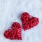 Two beautiful romantic vintage red hearts together on a white snow background. Love and St. Valentines Day concept.