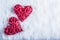 Two beautiful romantic vintage red hearts together on a white snow background. Love and St. Valentines Day concept.