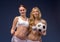 Two beautiful soccer fans hold the ball