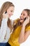 Two beautiful students laughing on the phone
