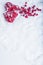 Two beautiful vintage red hearts with mistletoe berries on a white snow background. Christmas, love and St. Valentines Day concept