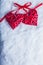 Two beautiful vintage red hearts tied together with a ribbon on a white snow background. Love and St. Valentines Day concept.