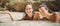 Two beautiful woman friends lying in shallow tropical sea