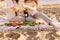 .Two beautiful women with blond hair in bright clothes. Sexy girls on the beach, romantic picnic with champagne and flowers. .Idea