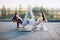 Two beautiful women doing acroyoga asana on the roof outdoors