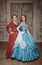 Two beautiful women medieval dresses