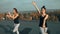 Two beautiful women practicing yoga asana on the roof, outdoors in morning