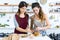 Two beautiful women preparing toasts with mashed vegetables, egg