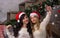 Two beautiful women in santa hats smiles make selfies near of Ch