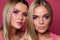 Two beautiful women sisters with makeup and long blonde hair close up portrait