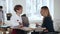 Two beautiful young Caucasian manager women talking standing at modern trendy office table. Healthy workplace.