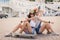 Two beautiful young girls on a skateboard in the city.