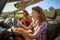 Two beautiful young women angry in traffic in a convertible car