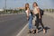 Two beautiful young women are hitchhiking on the road and try to find someone to take them to their hotel